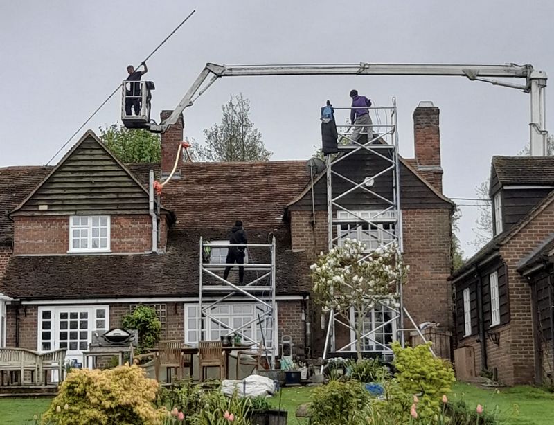 The Roof Moss Cleaners using cherry picker and scaffolding to clean roof safely and professionally in Wraysbury, Berkshire